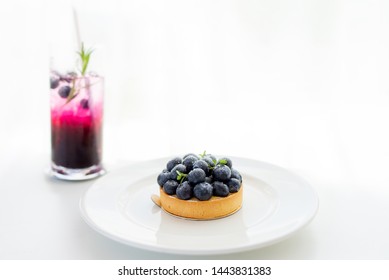 Blueberry cheesecake topping with fresh fruit blueberry on a table and white background with copy space. - Shutterstock ID 1443831383