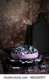 Blueberry cheesecakes topped with blueberries, coconut chips and flowers