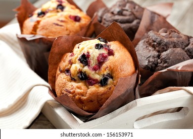 blueberry and chocolate muffins in paper cupcake holder