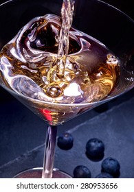 Blueberry gold drink with pouring cocktail on black background. Top view. - Shutterstock ID 280953656