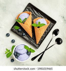 Blueberry Ice Cream In Waffle Cones With Berries And Mint Leaves. Overhead