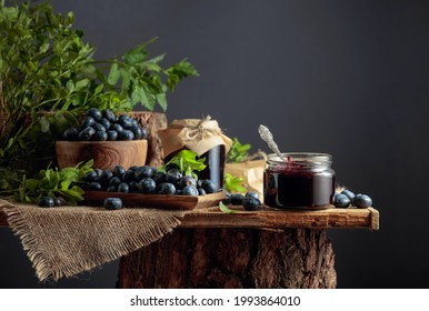 Blueberry Jam With Fresh Berries On An Old Wooden Table.