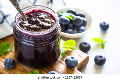 Blueberry jam in the glass jar with fresh berries. - Shutterstock ID 2167422959