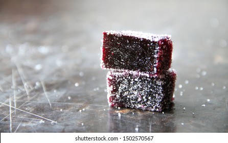 Blueberry Pate De Fruit (jelly, Marmalade, Fruit Candy) Covered With Sugar On A Dark Background, Back View. The Photo Of A Texture Inside Of Pate De Fruit.