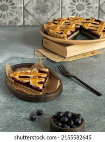 Blueberry Pie Decorated With A Lattice Of Dough. Berry Cake. Piece Of Blueberry Tart. Shortcrust Pastry Tart With Blueberry Filling