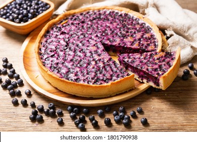 Blueberry Pie And Fresh Berries On A Wooden Table