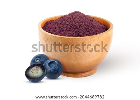 Blueberry powder in wooden bowl and fresh blueberries fruit isolated on white background. 