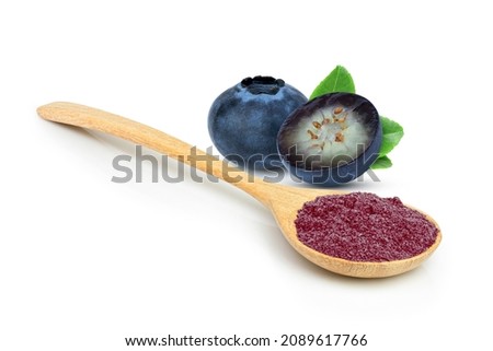 Blueberry powder in wooden spoon and fresh blueberries fruit with green leaf isolated on white background. 