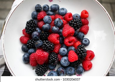 Blueberry, Raspberry And Blackberry Mix Background Inwhite Bowl
