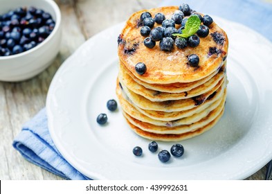 Blueberry Ricotta Pancakes on white wood background. toning. selective focus