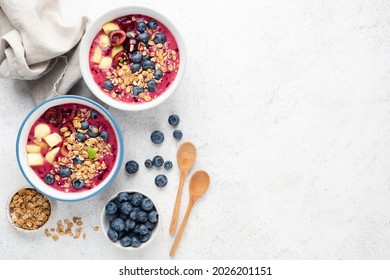 Blueberry Smoothie Bowl With Superfood Toppings On Grey Cement Background. Top View, Copy Space