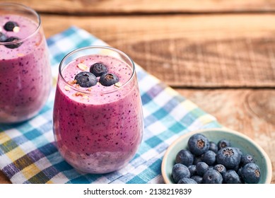 Blueberry Smoothie In Glass. Homemade Blueberry Smoothie On Rustic Wooden Table. Blueberry Smoothie With Yogurt And Oats.