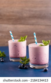 Blueberry Smoothie With Straws And Lime Garnish