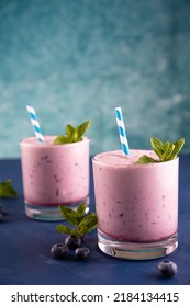 Blueberry Smoothie With Straws And Lime Garnish