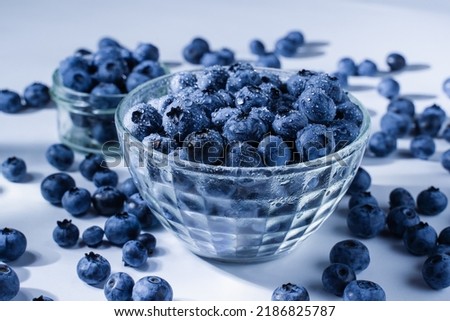 Blueberry with water drops. Blue berries in glass plate on white background. Many natural organic blueberries