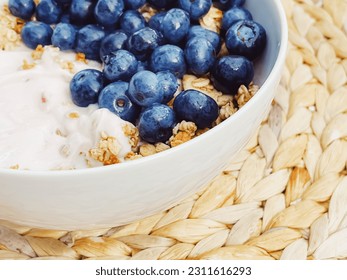 Blueberry yogurt cereal bowl as healthy breakfast and morning meal, sweet food and organic berry fruit, diet and nutrition concept - Shutterstock ID 2311616293