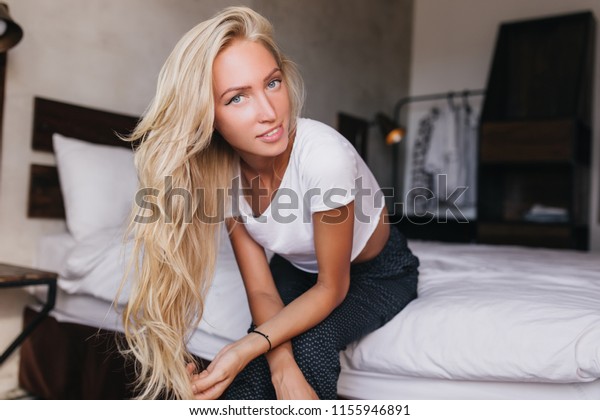 Blueeyed Girl Blonde Wavy Hair Sitting Stock Photo Edit Now