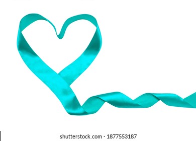 Blue-green Ribbon In The Form Of A Heart Isolates On A White Background. Symbol Of Sexual Violence, Polycystic Ovary Syndrome, Polycystic Kidney Disease, Gynecological Cancer, Ovarian Cancer, Miasthen