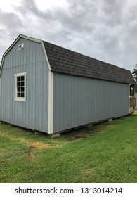 Blue-grey Pre-fab “shotgun” House On Country Field.