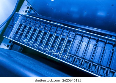A blue-lit data storage server showcases advanced technology in a modern IT environment. The intricate design highlights components essential for data management. - Powered by Shutterstock - Get 15% off with code: PIKWIZARD15