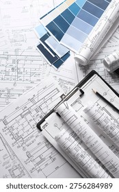 Blueprints, rolled plans and drafting tools on desk, architectural engineering workflow concept for construction planning, technical documentation, project management and building design.