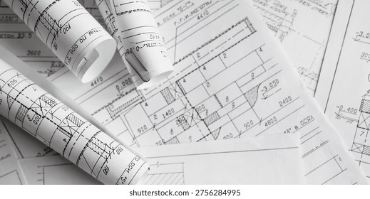 Blueprints, rolled plans and drafting tools on desk, architectural engineering workflow concept for construction planning, technical documentation, project management and building design.