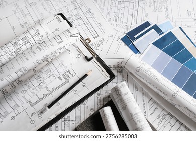 Blueprints, rolled plans and drafting tools on desk, architectural engineering workflow concept for construction planning, technical documentation, project management and building design.