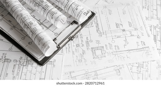 Blueprints, rolled plans and drafting tools on desk, architectural engineering workflow concept for construction planning, technical documentation, project management and building design.