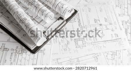 Blueprints, rolled plans and drafting tools on desk, architectural engineering workflow concept for construction planning, technical documentation, project management and building design.