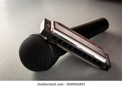 Blues Harp Or Harmonica With Microphone On Grey Table ,hobby Or Pastime .music Interest .