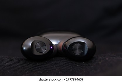 Bluetooth Black Earpods Isolated With Black Background