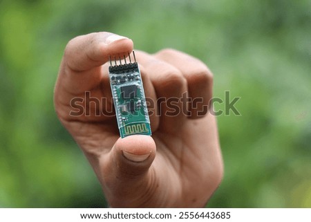 Bluetooth module used for wireless communication used in making robotics project held in the hand
