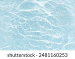 Bluewater waves on the surface ripples blurred. Defocus blurred transparent blue colored clear calm water surface texture with splash and bubbles. Water waves with shining pattern texture background.