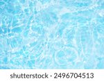 Bluewater waves on the surface ripples blurred. Defocus blurred transparent blue colored clear calm water surface texture with splash and bubbles. Water waves with shining pattern texture background.