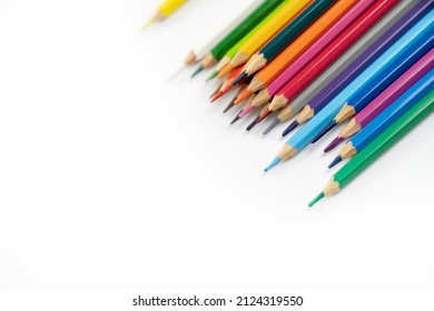 blunt colour pencils are arranged in the line on the white background and ready to paint.