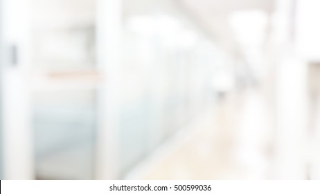 Blur Abstract Background Of Corridor In Clean Hospital. Blurry View Of Aisle In Office With Light Floor. Defocus Walkway In White Light Building Hall.