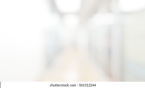 Blur Abstract Background Of Corridor In Clean Hospital. Blurry View Of Aisle In Office With Light Floor. Defocus Walkway In White Light Building Hall.