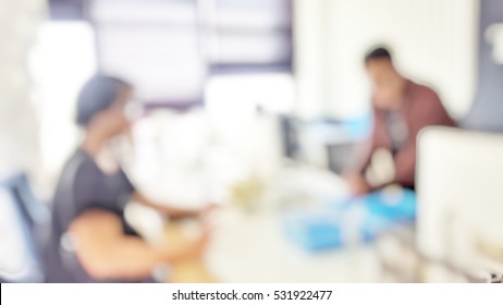 Blur Abstract Background Of Customer Register At Reception Desk In Hotel.  Defocus Traveller Checkin With Worker In Resort.Blurry Receptionist Taking Care Female Patient In Medical Clinic Hospital.