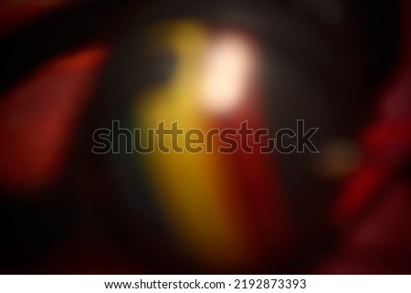 Blur abstract background in dark tone with black yellow and red from a defocused photo for use as background or backdrop with space for runaround or wraparound text 