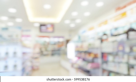 Blur Abstract Background Drugstore With Customers. Blurry View Of Drug Store And Pharmacist. Blurred Clean Pharmacy With Medicine On Shelves. Defocus White Drugstore.