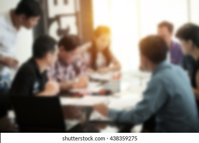 Blur Abstract Background Of Employees Young Colleagues Sitting At The Business Meeting In The Office.vintage Effect