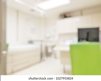 Blur Abstract Background Inside Empty Patient Examination Room For Kid With Bed In OPD Ward.Blurry Doctor Desk For Diagnosis Sick People Woking Space In Hospital.Defocused Interiors Healthcare Vintage