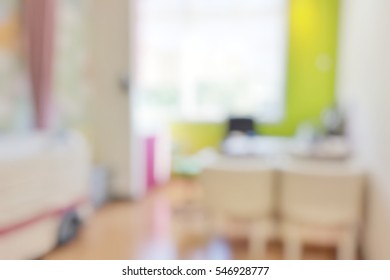 Blur Abstract Background Inside Empty Patient Examination Room For Kid With Bed In OPD Ward. Blurry Doctor Desk For Diagnosis Sick People Woking Space In Hospital. Defocused Interiors Healthcare Place