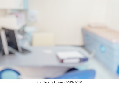 Blur Abstract Background Inside Empty Patient Examination Room For Kid With Bed In OPD Ward.Blurry Doctor Desk For Diagnosis Sick People Woking Space In Hospital.Defocused Interiors Healthcare Vintage