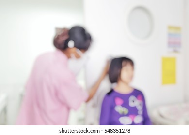 Blur Abstract Background Kid In Pediatrics Section Measuring Height And Weight.Blurry Children Healthcare, Hospital, Medicine Concept. Defocus Female Child Standing In Vital Sign Room With Nurse.