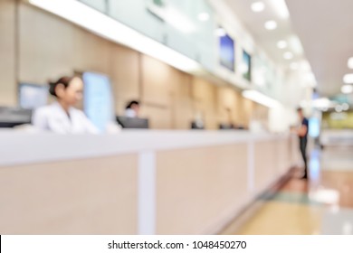 Blur Abstract Background Of Patients Register At Reception Desk In Hospital.  Blurry Nurse Receptionists Taking Care New Customers In Medical Clinic. Defocus Reception Area With Worker. Healthcare.