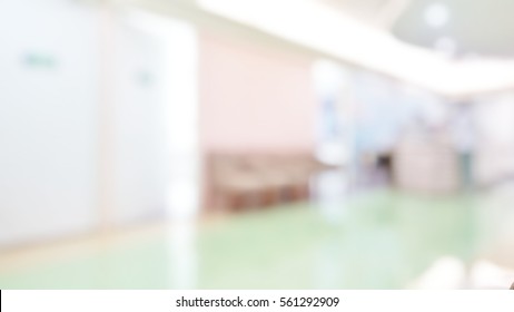 Blur Abstract Background Perspective View Of Waiting Zone Seat Row In Hospital Building Interior. Blurry Area Patients Wait To See Doctors, Opd Ward.Defocus Aisle Corridor To Exam Room In Clean Clinic