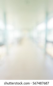 Blur Abstract Background Perspective View Of Aisle Bridge In Hospital Building Defocused Light Hallway Interior Corridor In Clean Clinic. Blurry View Of Outdoor  Walkway In Office Work Place