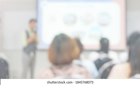 Blur Abstract Background Teacher In Front Of Classroom For Meet The Parent Day. Blurry Instructor Teaching In School. Defocus Open House Day At Campus For Kindergarten Students.American Education Week