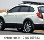 Blur abstract background of a white SUV with roof rack